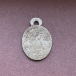 Silver pendant with intricate design geisha