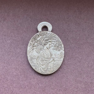 Silver pendant with intricate design geisha