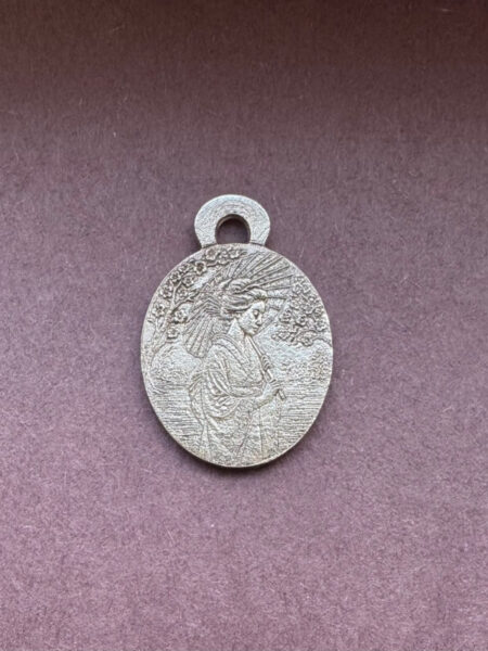 Silver pendant with intricate design geisha