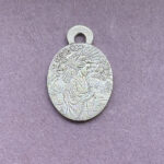 Silver pendant with intricate design geisha